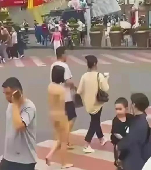 一名女子在广场上赤裸裸地走街上,引来众多群众的围观和猜疑